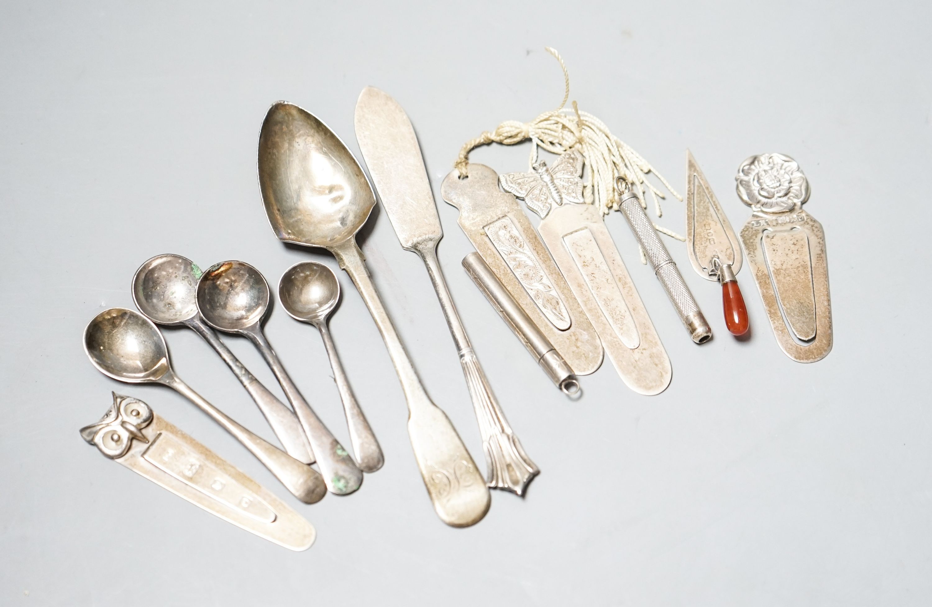 Five assorted silver bookmarks, a white metal cased toothpick, spoons etc.
